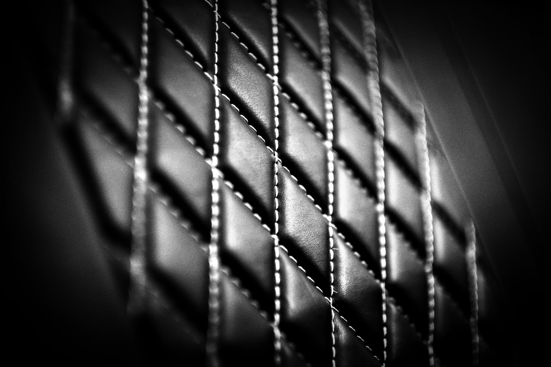 Diamond-stitched black leather upholstery in close detail