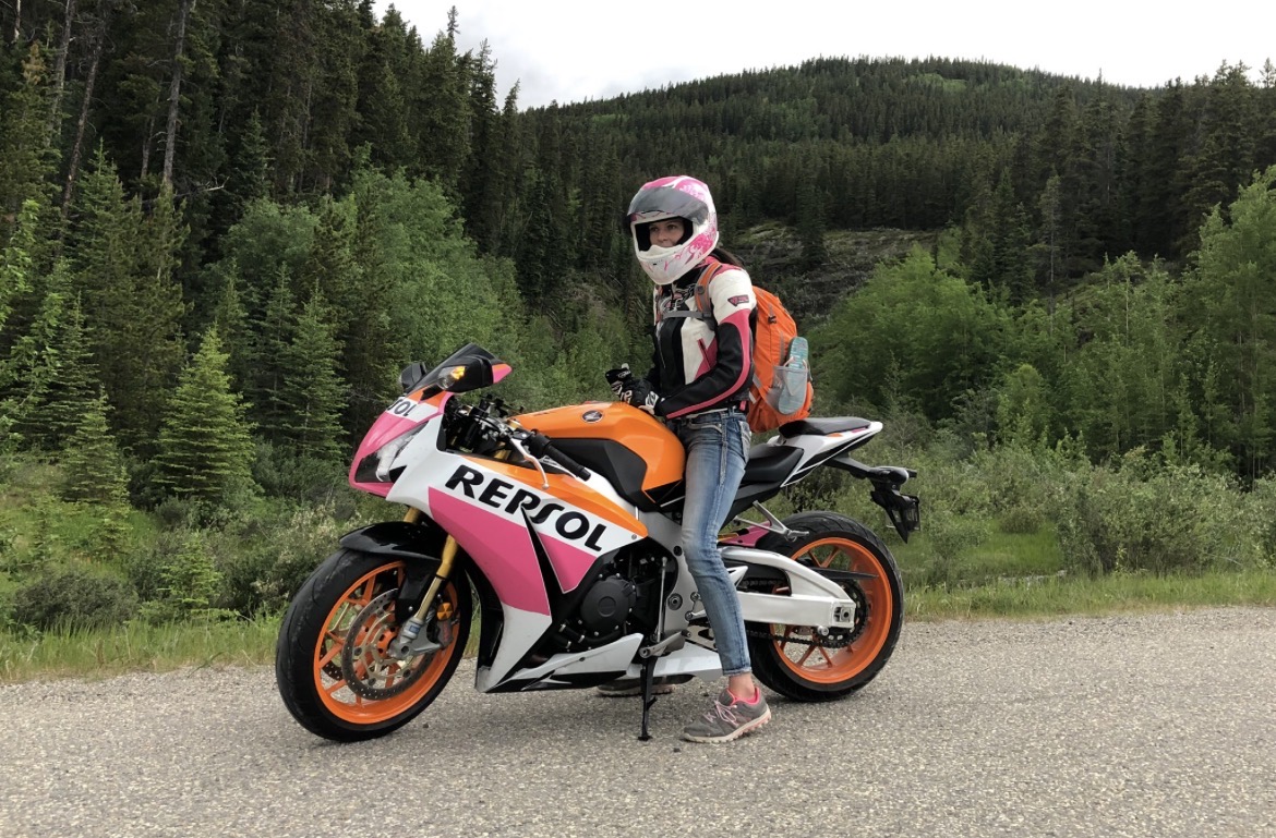 Beside the Repsol sportbike on a forest road in the foothills