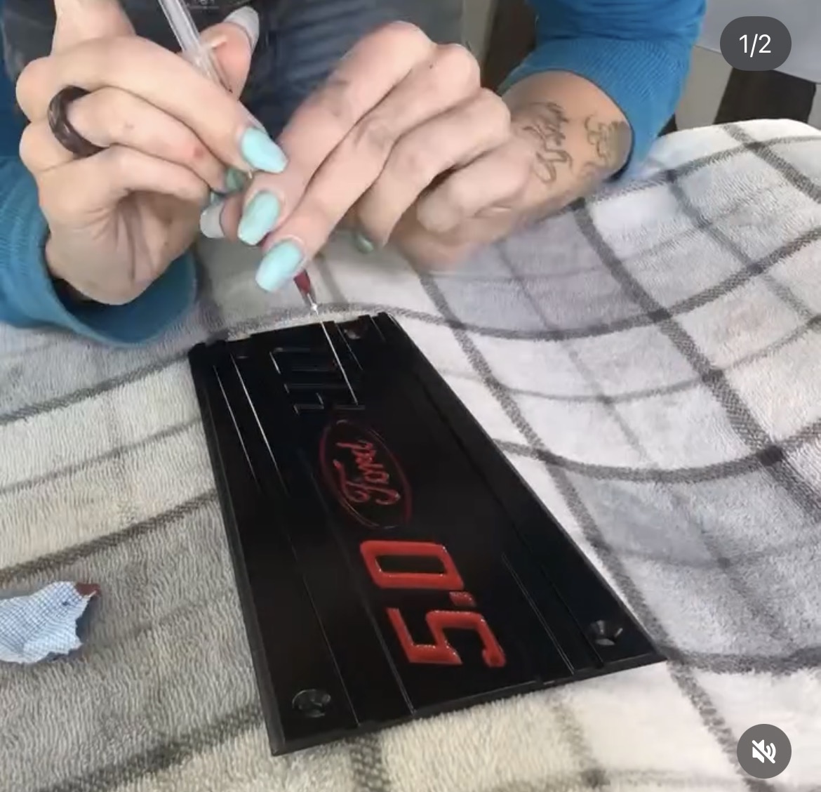 Hand-detailing the lettering on a valve cover