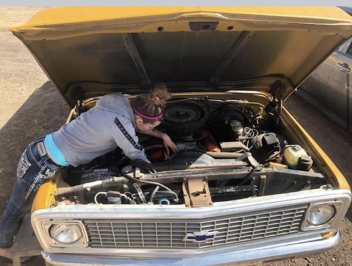 Working under the hood of a classic pickup