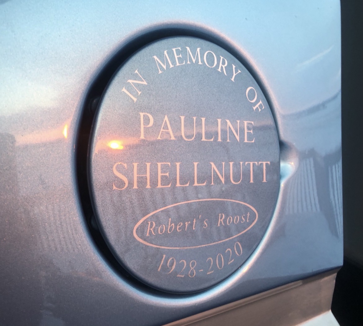 Hand-lettered memorial graphic finished on a fuel door