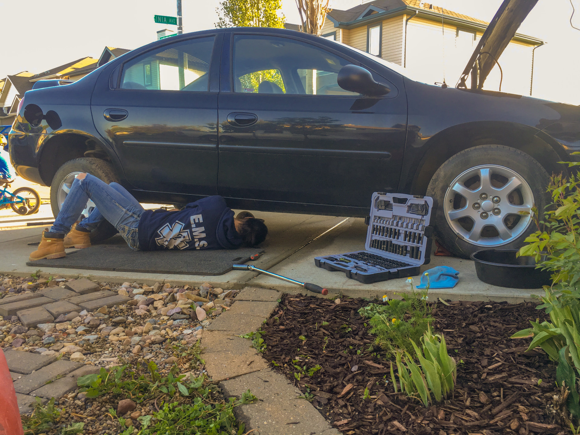 Working on a car in the driveway on a summer afternoon